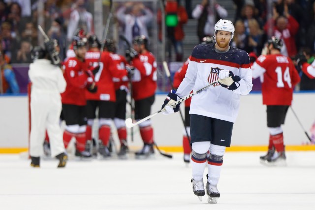 U.S. forward Joe Pavelski skates away as Canada celebrates its semifinal win.  (Winslow Townson, USA TODAY Sports)