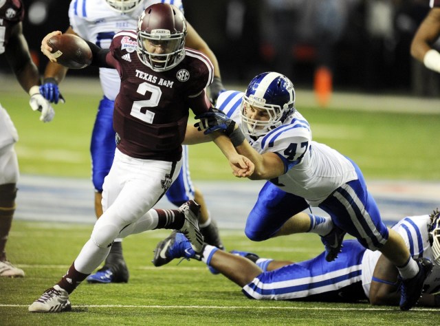 Texas A&M Aggies quarterback Johnny Manziel carries the ball past Duke Blue Devils linebacker David Helton (47) during the third quarter in the 2013 Chick-fil-a Bowl. (Dale Zanine-USA TODAY Sports)