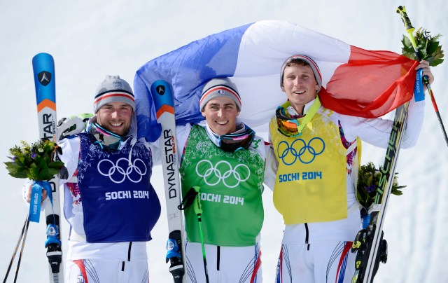 French skiers Arnaud Bovolenta (blue) and Jean Frederic Chapuis (green) and Jonathan Midol (yellow) celebrate on the podium after the final for men's ski cross during the Sochi 2014 Olympic Winter Games at Rosa Khutor Extreme Park. (Jack Gruber-USA TODAY Sports)