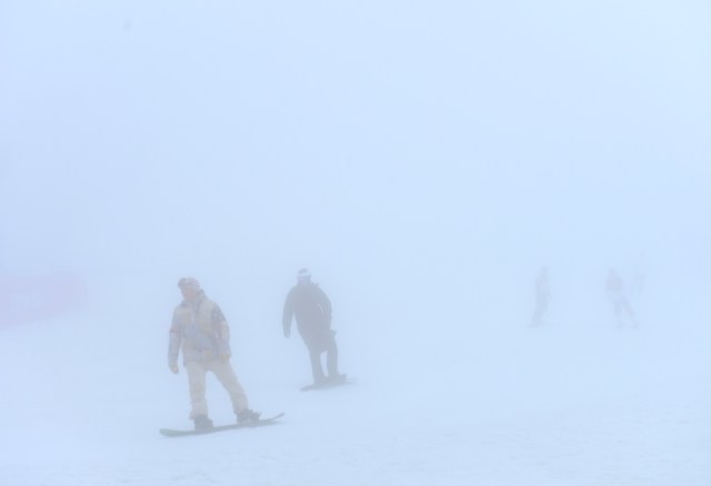 Snowboarders warm up in the fog at Rosa Khutor Extreme Park. (Jack Gruber, USA TODAY Sports)