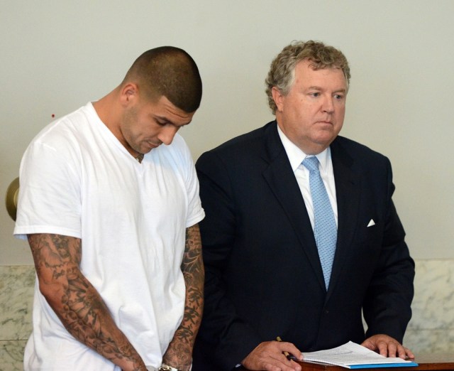 New England Patriots former tight end Aaron Hernandez (left) stands with his attorney Michael Fee as he is arraigned in Attleboro District Court. Hernandez is charged with first degree murder in the death of Odin Lloyd. (The Sun Chronicle/Pool Photo via USA TODAY Sports)