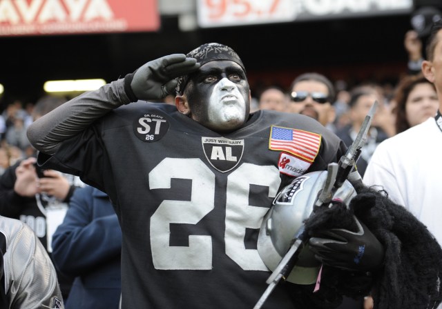 Fan in the Black Hole salutes during National Anthem in an preseason game between the Oakland Raiders and the Dallas Cowboys at O.co Coliseum. (Bob Stanton - USA TODAY Sports)