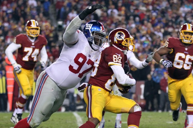New York Giants defensive tackle Linval Joseph attempts to tackle Washington Redskins wide receiver Santana Moss at FedEx Field.  (Geoff Burke - USA TODAY Sports)