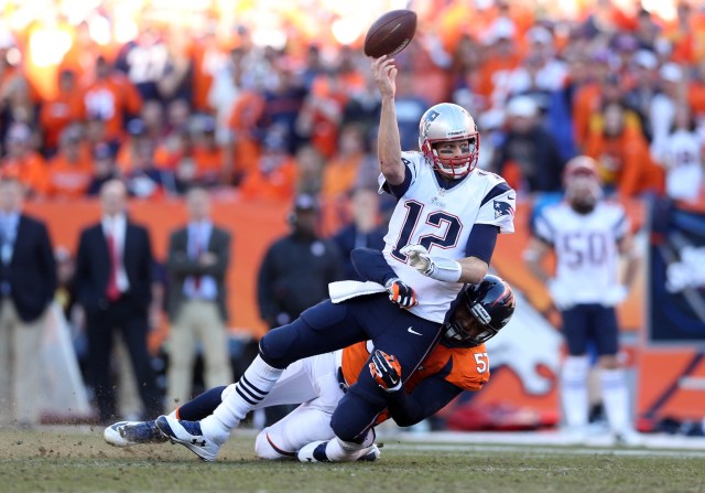 New England Patriots quarterback Tom Brady is brought down by Denver Broncos defensive end Jeremy Mincey in the second half of the 2013 AFC Championship football game at Sports Authority Field at Mile High. (Mark J. Rebilas - USA TODAY Sports)