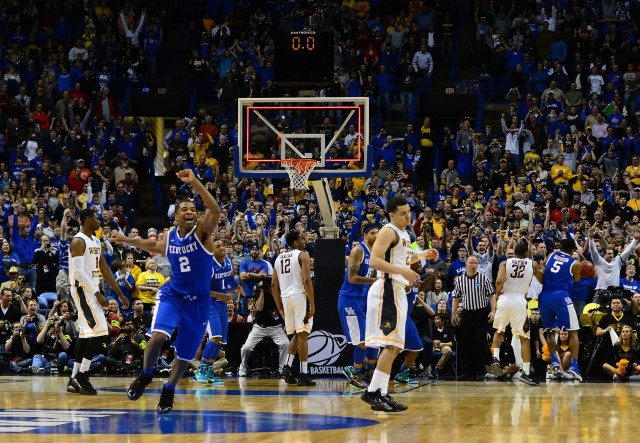 Kentucky Wildcats guard Aaron Harrison (2) celebrates as Wichita State Shockers guard Fred VanVleet (23) missed a three point shot with 1.6 seconds left in the third round of the 2014 NCAA Men's Basketball Championship at Scottrade Center. Kentucky defeated Wichita State 78-76. Jasen Vinlove-USA TODAY Sports.