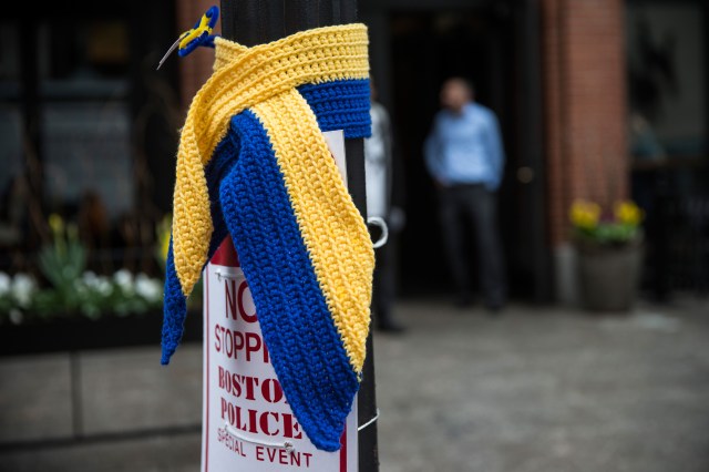 A knitted tribute hangs on a street light along the course of the Boston Marathon on the one year anniversary of the 2013 Boston Marathon Bombing.  (Photo by Andrew Burton/Getty Images)
