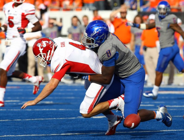 Fresno State Bulldogs quarterback Derek Carr fumbles the ball after being tackled Boise State Broncos defensive lineman Demarcus Lawrence at Bronco Stadium. (Brian Losness-USA TODAY Sports)