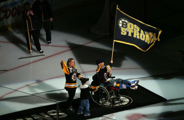 Boston Marathon bombing victim Marc Fucarile waves the Boston strong flag before game four of the 2013 Stanley Cup Final between the Boston Bruins and Chicago Blackhawks at TD Garden. (Greg M. Cooper - USA TODAY Sports)