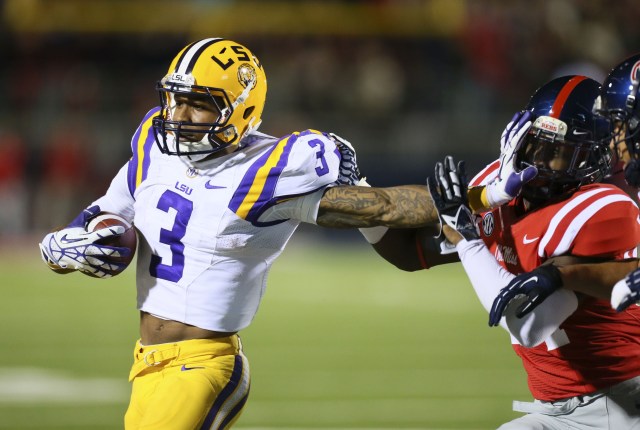 LSU Tigers wide receiver Odell Beckham advances the ball and stiff arms Mississippi Rebels linebacker Keith Lewis at Vaught-Hemingway Stadium. (Spruce Derden - USA TODAY Sports)