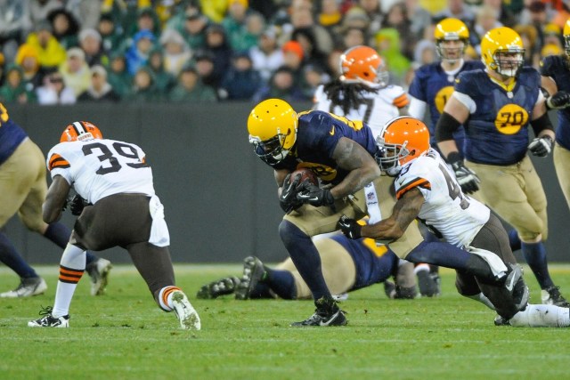 Green Bay Packers tight end Jermichael Finley is tackled by Cleveland Browns defensive back T.J. Ward and defensive back Tashaun Gipson at Lambeau Field. Finley was injured on the play and had to be taken off the field on a stretcher. (Benny Sieu - USA TODAY Sports)