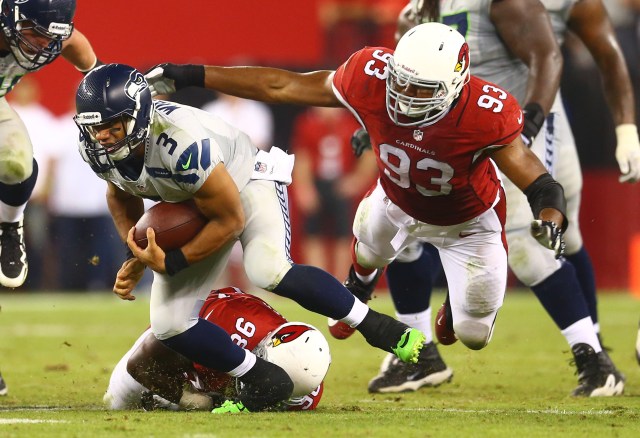 Seattle Seahawks quarterback Russell Wilson is pursued by Arizona Cardinals defensive end Calais Campbell during a game at University of Phoenix Stadium. (Mark J. Rebilas - USA TODAY Sports)