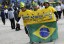Supporters of Brazil's national soccer team share shirt an oversized reading "we go for the sixth Cup win" as they arrive for the opening match of the soccer World Cup between Brazil and Croatia at the Arena de Sao Paulo in Sao Paulo. (REUTERS/Kai Pfaffenbach)
