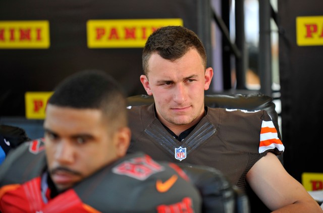 Johnny Manziel's slow transition to the NFL is reminiscent of another hyped Heisman winner. (Gary A. Vasquez, USA TODAY Sports)