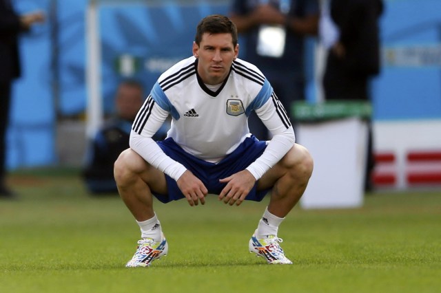 Argentina star Lionel Messi stretches during training. (Marko Djurica, REUTERS)