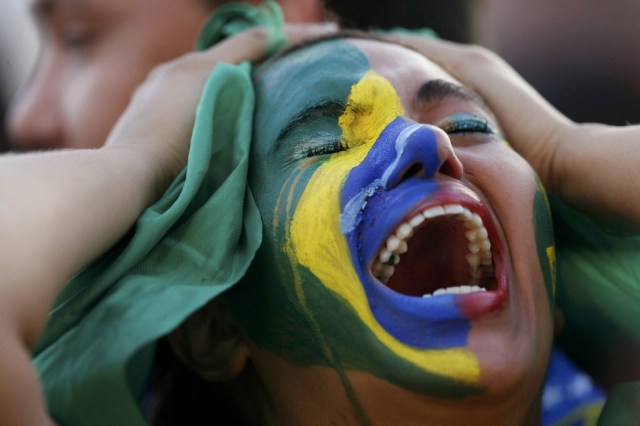Fans of Brazil react while watching a broadcast of the 2014 World Cup semi-final against Germany at the Fan Fest in Brasilia. (Ueslei Marcelino, REUTERS)
