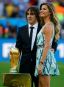 Retired footballer Carles Puyol of Spain (L), a member of the 2010 World Cup winning team, and Brazilian supermodel Gisele Bundchen pose with the World Cup trophy. (REUTERS/Kai Pfaffenbach)