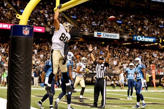 Jimmy Graham (80) celebrates by dunking over the goalpost following a touchdown against the Tennessee Titans. (Derick E. Hingle-USA TODAY Sports)