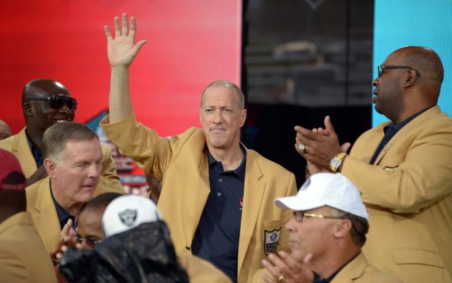 Jim Kelly waves to the crowd at the 2014 Pro Football Hall of Fame Enshrinement at Fawcett Stadium. (Credit: USA TODAY Sports)