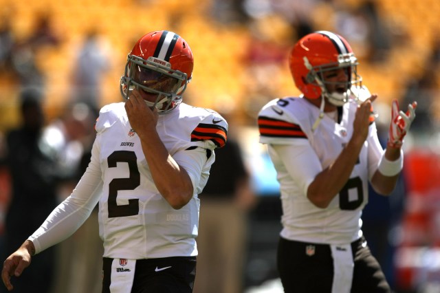 Johnny Manziel, left, was on the sidelines in the first half as Brian Hoyer struggled for the Cleveland Browns.