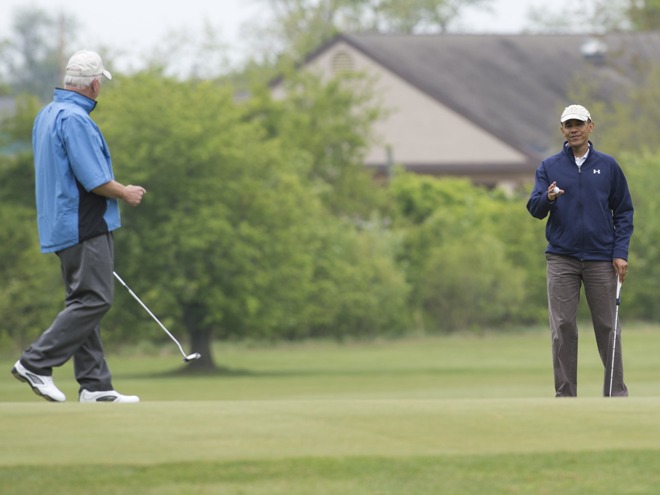 Senator Saxby Chambliss and President Barack Obama chat early in Monday's round. 