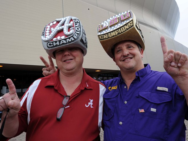 A couple of football fans showing off their rings at the 2011 National Championship Game. (John David Mercer/US PRESSWIRE)