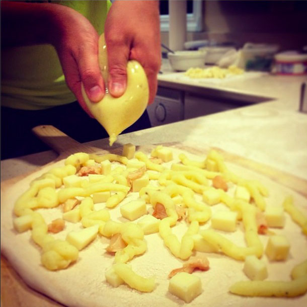 Piping the pizza. (Photo: Rubie Edmondson)