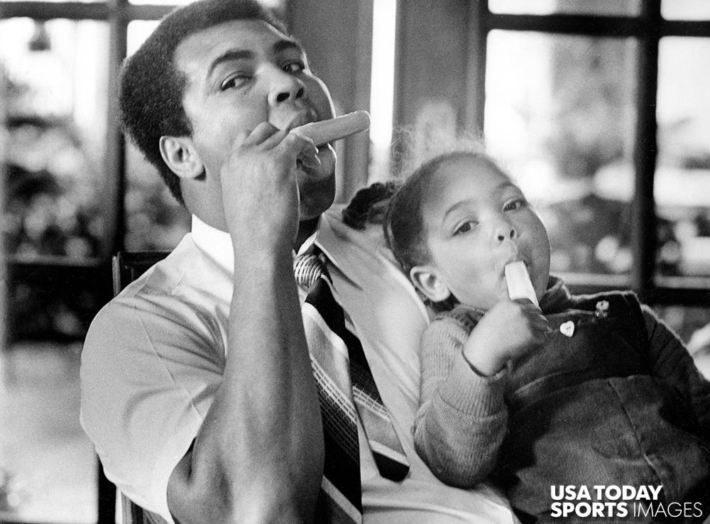 Former heavyweight champion Muhammad Ali shares a popsicle with his daughter Hana Ali at home in Louisville, Kentucky in 1980.  //  Credit; Keith Williams, The Courier-Journal, USA TODAY Sports