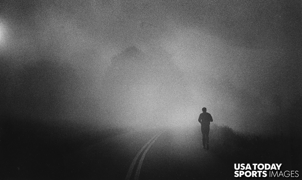 Muhammad Ali takes his daily three-mile run along a Pennsylvania country road shrouded in early morning fog near his Deer Lake training camp in 1978.  //  Credit: Keith Williams, The Courier-Journal, USA TODAY Sports