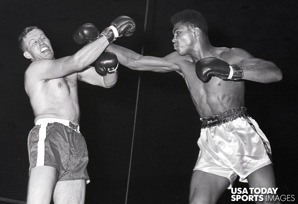 Muhammad Ali, then Cassius Clay (right), in his first professional bout with Tunney Hunsaker (left) at Freedom Hall on October 30, 1960.  //  Credit: Warren Klosterman, The Courier-Journal, USA TODAY Sports