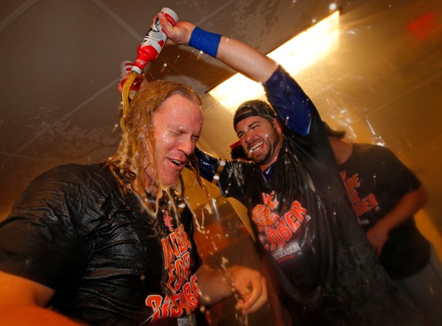 PHILADELPHIA, PA - OCTOBER 01: Noah Syndergaard #34, left, of the New York Mets is drenched with beer by Kevin Plawecki #26 after the Mets defeated the Philadelphia Phillies 5-3 during a game at Citizens Bank Park on October 1, 2016 in Philadelphia, Pennsylvania. The win clinched a Wild Card game for the Mets. (Photo by Rich Schultz/Getty Images)