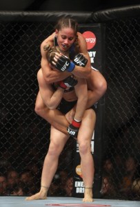 ANAHEIM, CA - FEBRUARY 23: Liz Carmouche gets Ronda Rousey in a neck crank during their UFC Bantamweight Title fight at Honda Center on February 23, 2013 in Anaheim, California. (Photo by Jeff Gross/Getty Images)