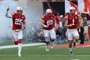 LINCOLN, NE - OCTOBER 01: Safety Nathan Gerry #25 and offensive lineman Dylan Utter #66 and wide receiver Jordan Westerkamp #1 of the Nebraska Cornhuskers take the field before the game against the Illinois Fighting Illini at Memorial Stadium on October 1, 2016 in Lincoln, Nebraska. (Photo by Steven Branscombe/Getty Images)