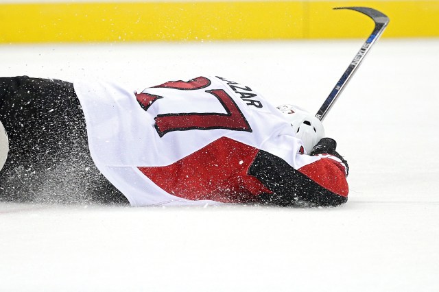WASHINGTON, DC - DECEMBER 16: Curtis Lazar #27 of the Ottawa Senators lays on the ice after taking a hit in the third period against the Washington Capitals at Verizon Center on December 16, 2015 in Washington, DC. (Photo by Patrick Smith/Getty Images)