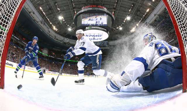 VANCOUVER, BC - DECEMBER 16: Henrik Sedin #33 of the Vancouver Canucks and Andrei Vasilevskiy #88 of the Tampa Bay Lightning watch Victor Hedman #77 of the Lightning direct the puck past the post during their NHL game at Rogers Arena December 16, 2016 in Vancouver, British Columbia, Canada. (Photo by Jeff Vinnick/NHLI via Getty Images)
