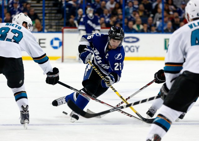 TAMPA, FL - JANUARY 18: Martin St. Louis #26 of the Tampa Bay Lightning tries to get past Matt Nieto #83 of the San Jose Sharks at the Tampa Bay Times Forum on January 18, 2014 in Tampa, Florida. (Photo by Mike Carlson/Getty Images)