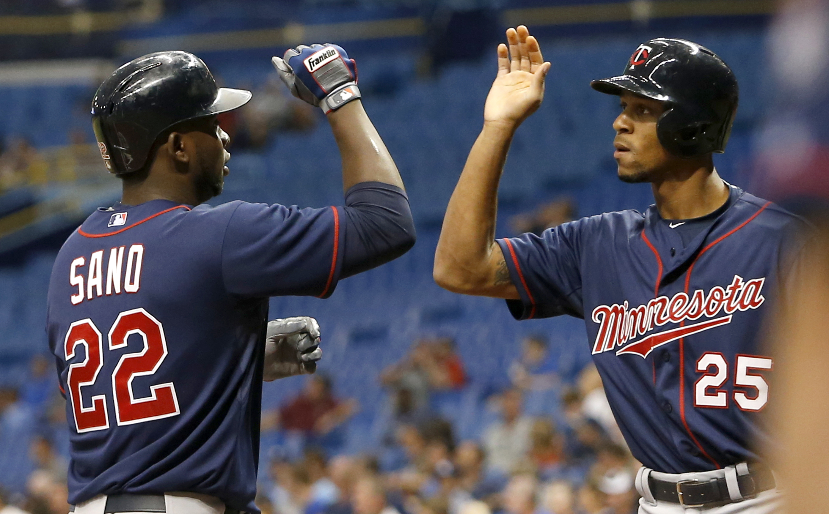 ST. PETERSBURG, FL - AUGUST 25:  Miguel Sano #22 of the Minnesota Twins celebrates at the plate with teammate Byron Buxton #25 following his three-run home run during the first inning of a game against the Tampa Bay Rays on August 25, 2015 at Tropicana Field in St. Petersburg, Florida.  (Photo by Brian Blanco/Getty Images)