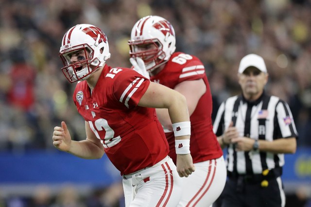 ARLINGTON, TX - JANUARY 02: Alex Hornibrook #12 and Beau Benzschawel #66 of the Wisconsin Badgers celebrate after a touchdown in the fourth quarter during the 81st Goodyear Cotton Bowl Classic between Western Michigan and Wisconsin at AT&T Stadium on January 2, 2017 in Arlington, Texas. (Photo by Ronald Martinez/Getty Images)