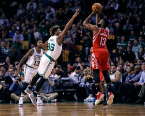 Boston Celtics guard Marcus Smart (36) tries to block a shot by Houston Rockets guard James Harden (13) during the first quarter of an NBA basketball game in Boston, Wednesday, Jan. 25, 2017. (AP Photo/Charles Krupa)
