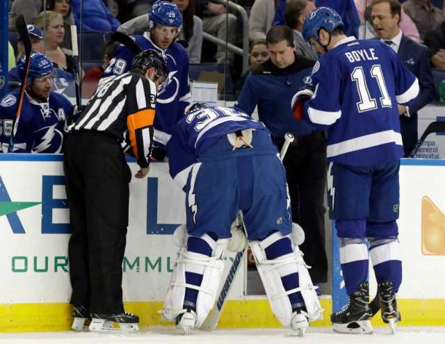 Tampa Bay Lightning goalie Ben  Bishop (30) is helped off the ice by center <a rel=