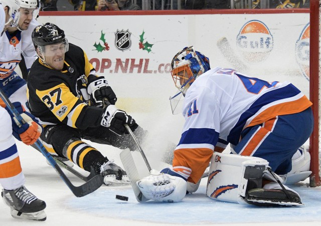 ec 7, 2017; Pittsburgh, PA, USA;Pittsburgh Penguins right wing Carter Rowney (37) shoots the puck against New York Islanders goalie Jaroslav Halak (41) during the second period of an NHL hockey game at PPG PAINTS Arena. Mandatory Credit: Don Wright-USA TODAY Sports
