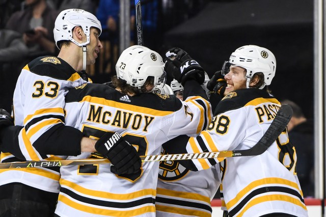 Jan 18, 2018; Brooklyn, NY, USA; Boston Bruins celebrate the hat trick of Boston Bruins center Patrice Bergeron (37) against the New York Islanders during the third period at Barclays Center. Mandatory Credit: Dennis Schneidler-USA TODAY Sports