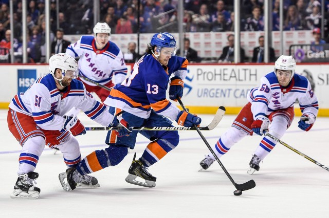 Feb 15, 2018; Brooklyn, NY, USA; New York Islanders center Mathew Barzal (13) brings the puck into the zone defended by New York Rangers center David Desharnais (51) and defenseman John Gilmour (58) during the second period at Barclays Center. Mandatory Credit: Dennis Schneidler-USA TODAY Sports