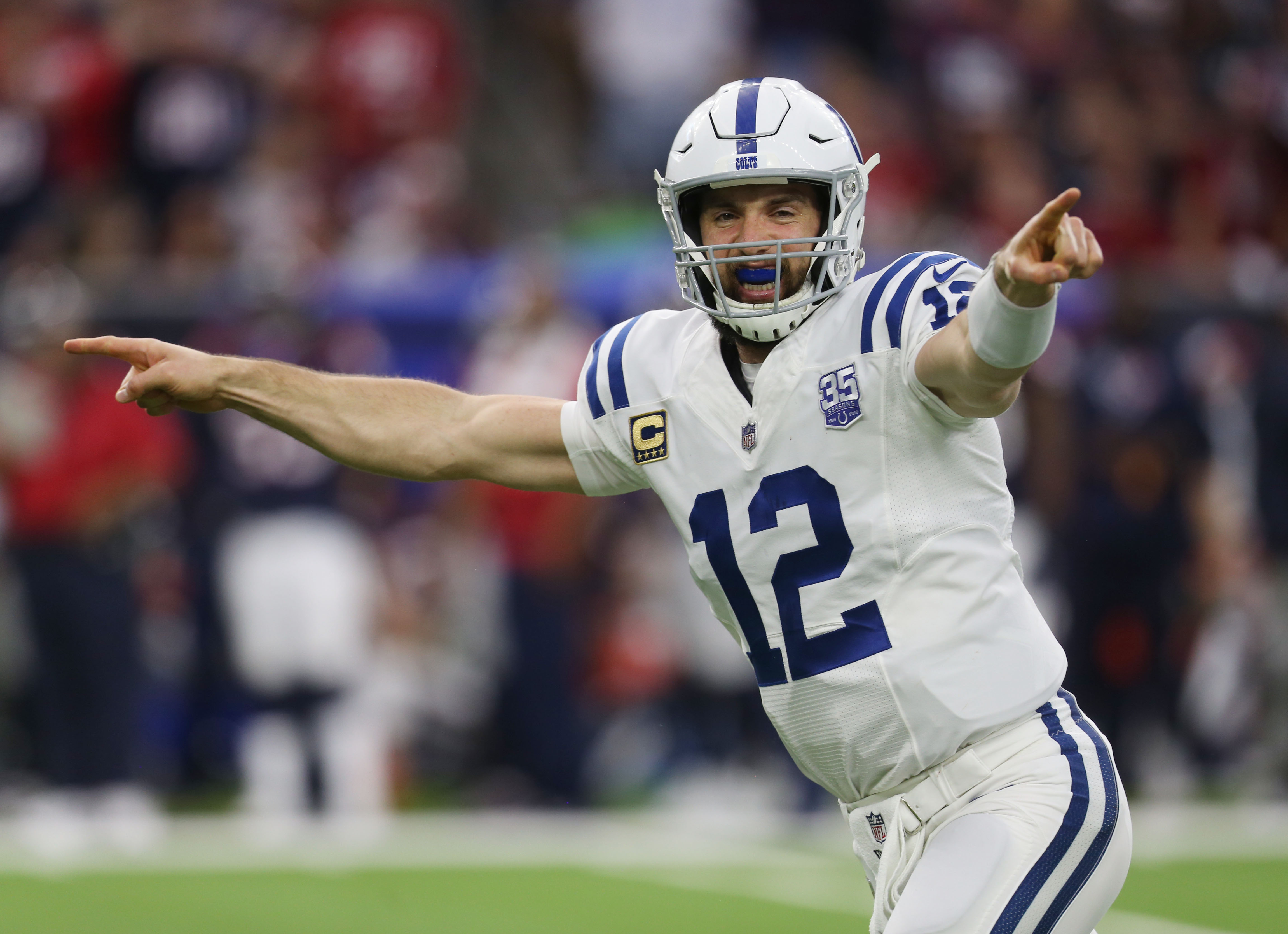 Indianapolis Colts' Andrew Luck (12) throws as Houston Texans' J.J. Watt  (99) applies pressure during the first quarter of an NFL football game,  Thursday, Oct. 9, 2014, in Houston. (AP Photo/David …