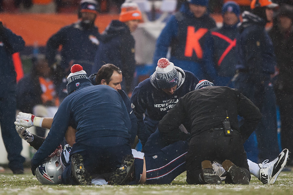 DENVER, CO - NOVEMBER 29: New England Patriots trainers tend to Rob Gronkowski #87 after he sustained a leg injury during a game against the Denver Broncos at Sports Authority Field at Mile High on November 29, 2015 in Denver, Colorado. The Broncos beat the Patriots 30-24 in overtime. (Photo by Dustin Bradford/Getty Images)