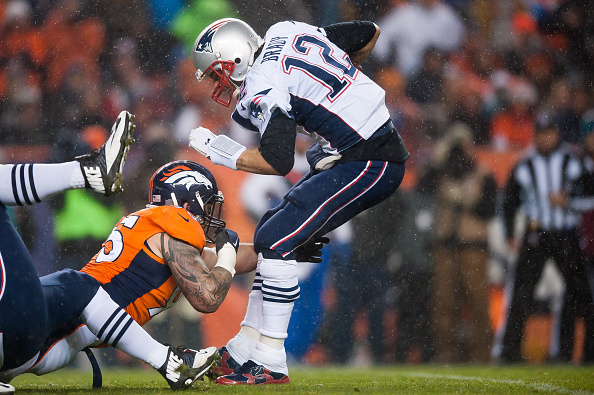 New England Patriots quarterback Tom Brady is sacked by defensive end Derek Wolfe Number 95 of the Denver Broncos in the first quarter at Sports Authority Field at Mile High on November 29, 2015 in Denver, Colorado. (Photo by Dustin Bradford/Getty Images)