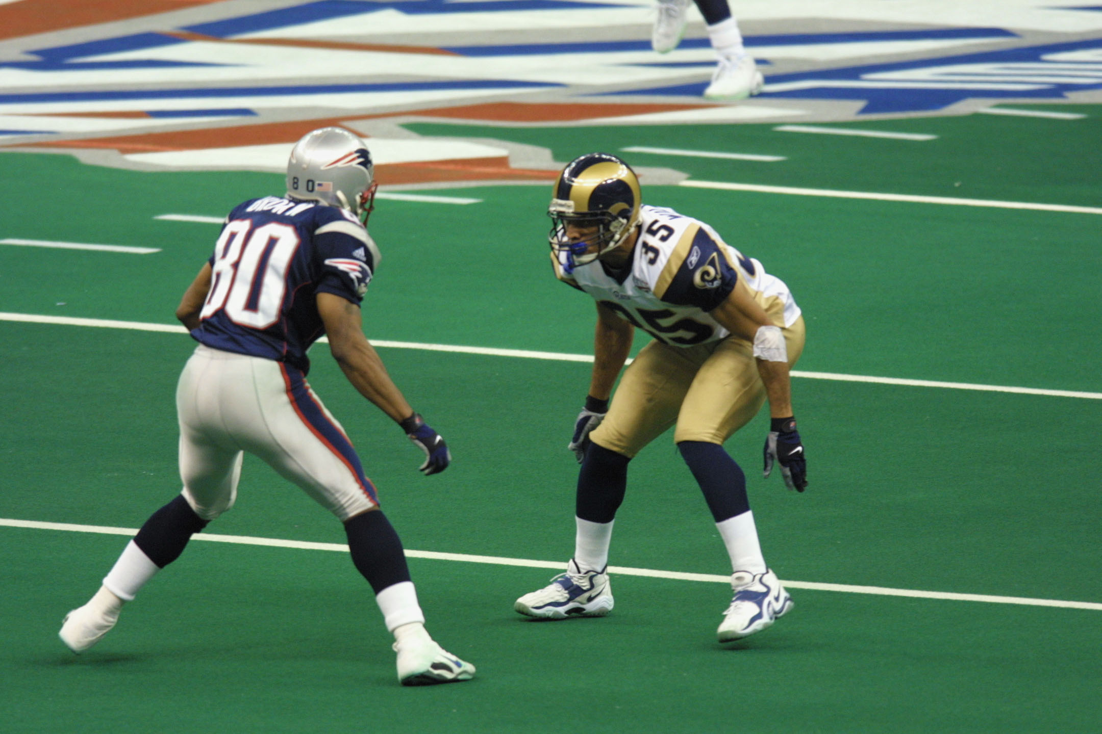 Denver's cornerback Champ Bailey kneels and grimaces in between