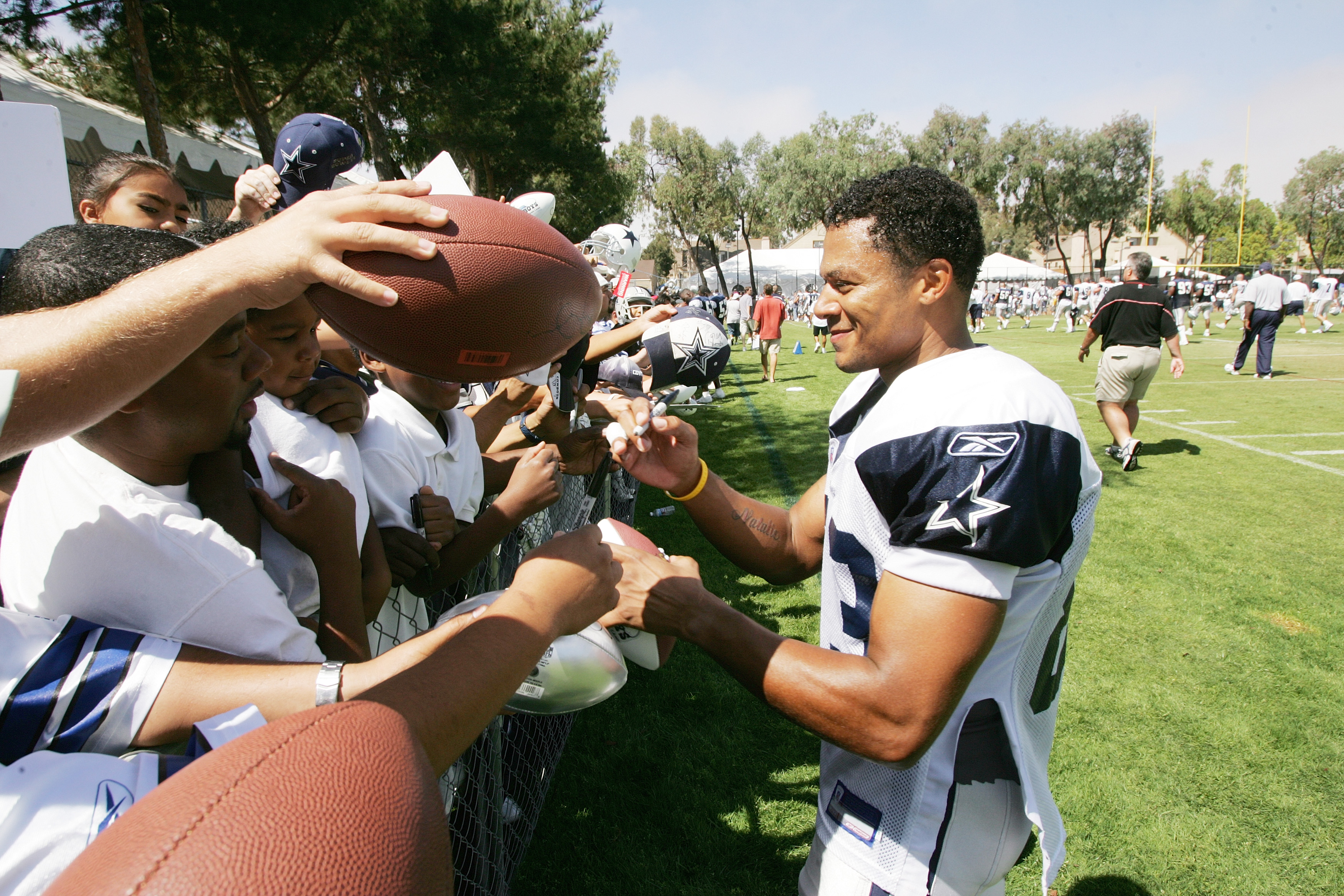 Dallas Cowboys wide receiver Terry Glenn covers up the ball after