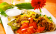 Tender beef simmered in salsa provides a deep, rich flavor upon which to pile grilled fresh peppers and chopped tomatoes all cooled down with a cilantro lime crema.
