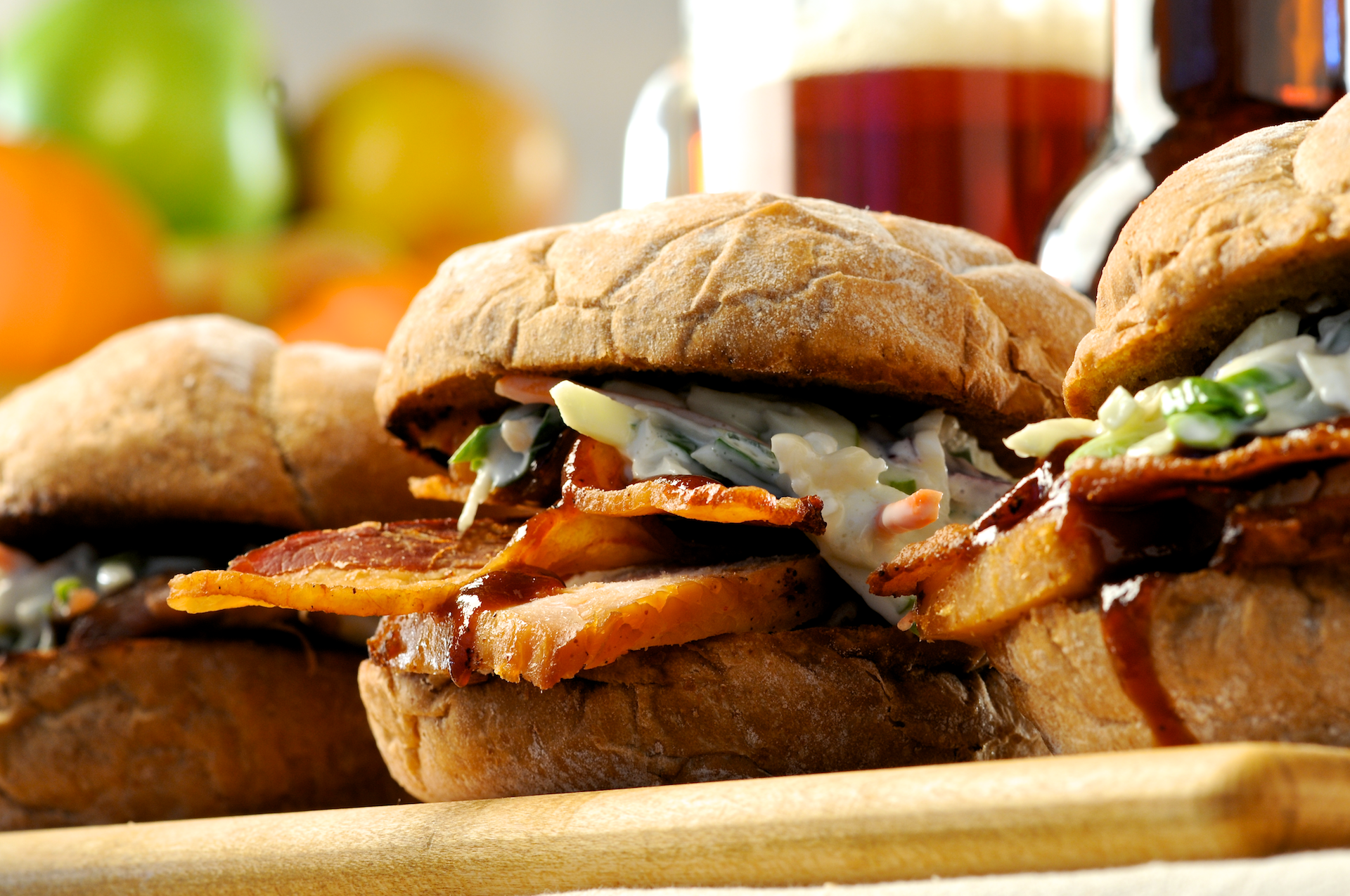 Hearty BBQ smoked chicken or pulled pork sandwiches layered on toasted Kaiser rolls with crisp Applewood-Smoked bacon, smoky-sweet cider barbecue sauce and crunchy apple slaw. Tasty!