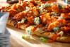 Everything you love about crispy chicken tossed in a buttery, hot-and-spicy Buffalo sauce piled on a golden bubbly cheese pizza garnished with crumbled bleu cheese, fresh-chopped green onions and even more zesty Buffalo sauce.